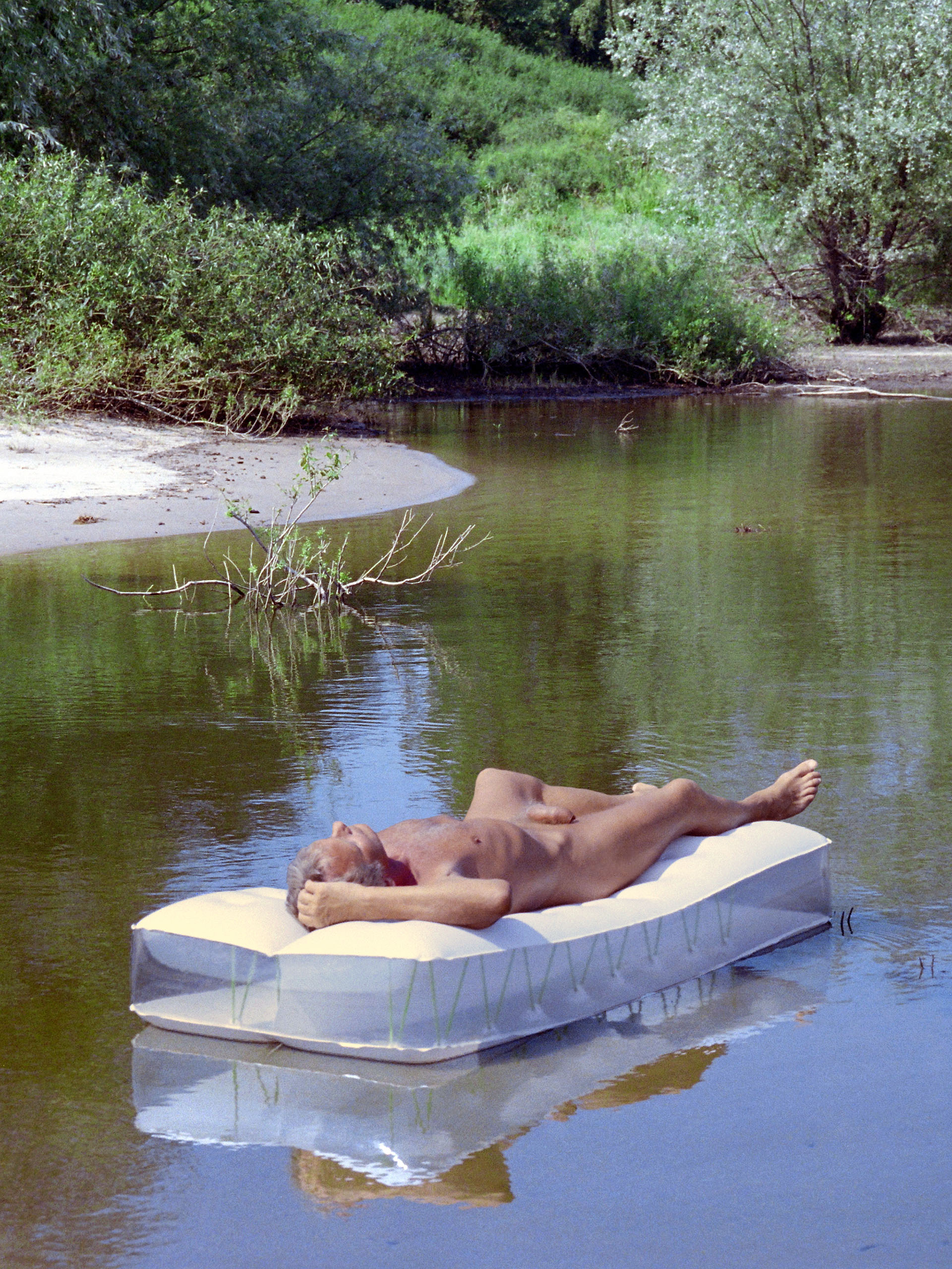 Nudism - nude bathing in the Elbe, naked man sunbathing